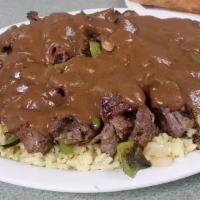 Steak Bites · Served with grilled onions and green peppers over rice topped with brown gravy.