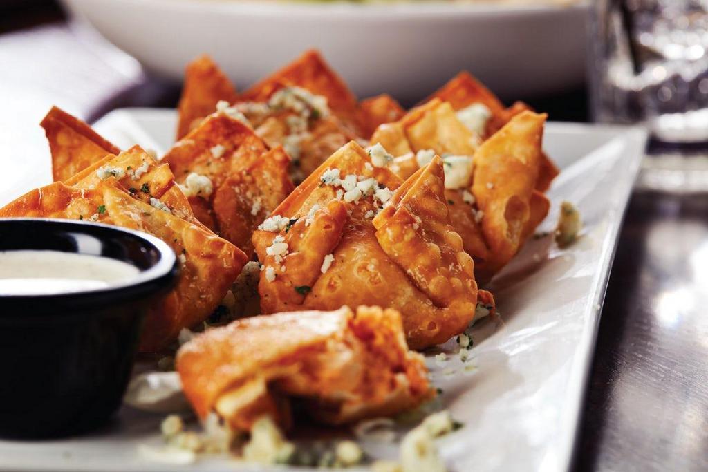 Buffalo Chicken Wontons · Crispy fried wontons filled with pockets of Big Whiskey's Buffalo Chicken Dip and sprinkled with bleu cheese crumbles. Served with ranch dressing.