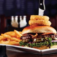 Big Whiskey Bbq Burger · Topped with golden onion rings, crisp bacon and a side of our honey whiskey BBQ sauce