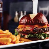 Pretzel Burger · Served on a butter toasted pretzel bun with lettuce, tomatoes, horseradish aioli and topped ...