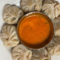 Chicken Momo Nepali Dumplings (8 Pcs) · Chicken and vegetables fillings marinated in Nepali spices hand-wrapped in homemade dough, s...