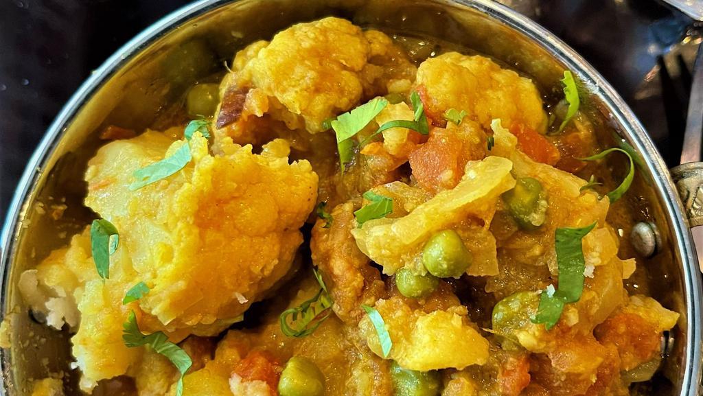 Tarkari (Comes With Rice) · Vegetables curry (potatoes, cauliflower, green peas, and tomatoes) with onion, garlic, ginger and flavorful spices