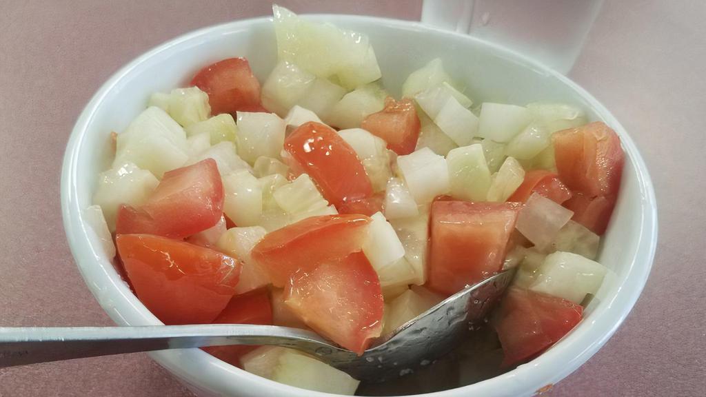 Persian Salad · Chopped cucumber, chopped tomatoes, chopped onion with lime juice, olive oil and salt.