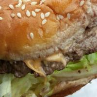 Big Cheeseburger · One 1/3 lb. beef burger served with American cheese in a big toasted sesame seed bun  with y...