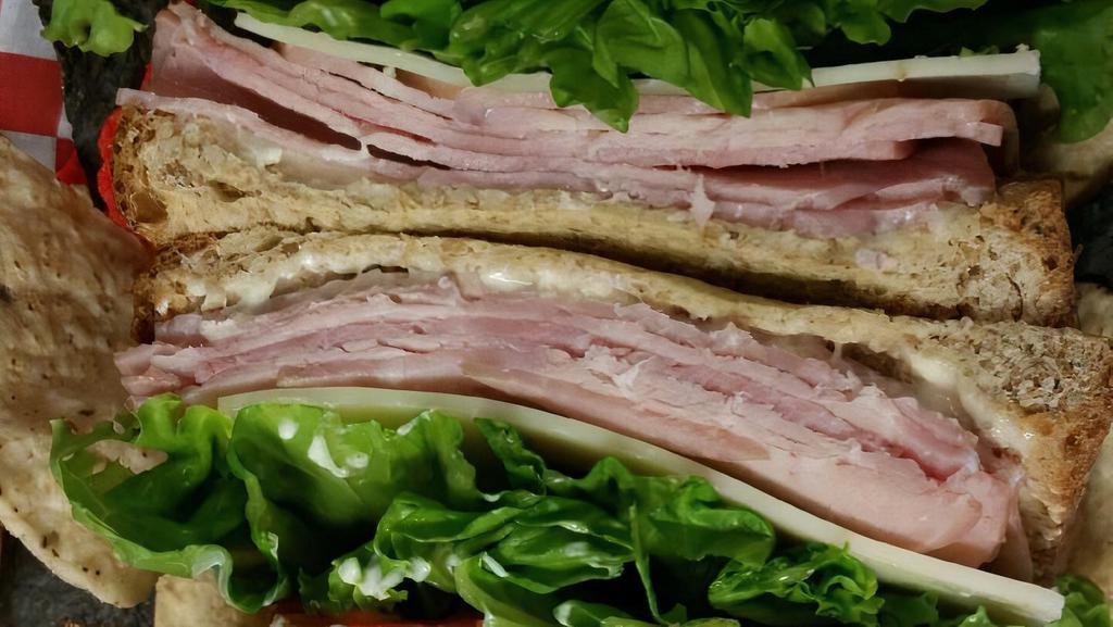 Ham And Swiss · Protein-20g, Carbs-30g, Fat-21g, Fiber-3g, 520 Calories.
Hickory smoked sliced ham, Swiss cheese, lettuce, roma
tomatoes, and light mayo served on wheat bread.