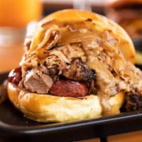Smokehouse Sandwich · Sliced brisket, pulled pork, sausage, caramelized onions, housemade pickles and habanero mus...