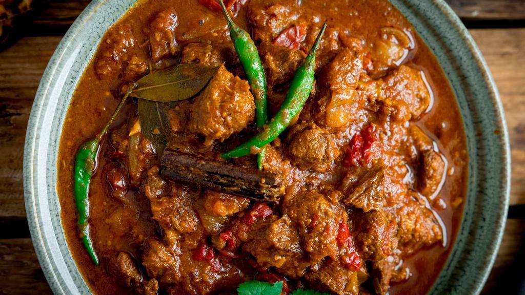 Lamb Bhuna · Marinated lamb cooked with spices and herbs.