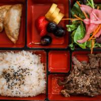 Korean Lunch Box · Rice, protein, salad, two dumplings, and miso soup.