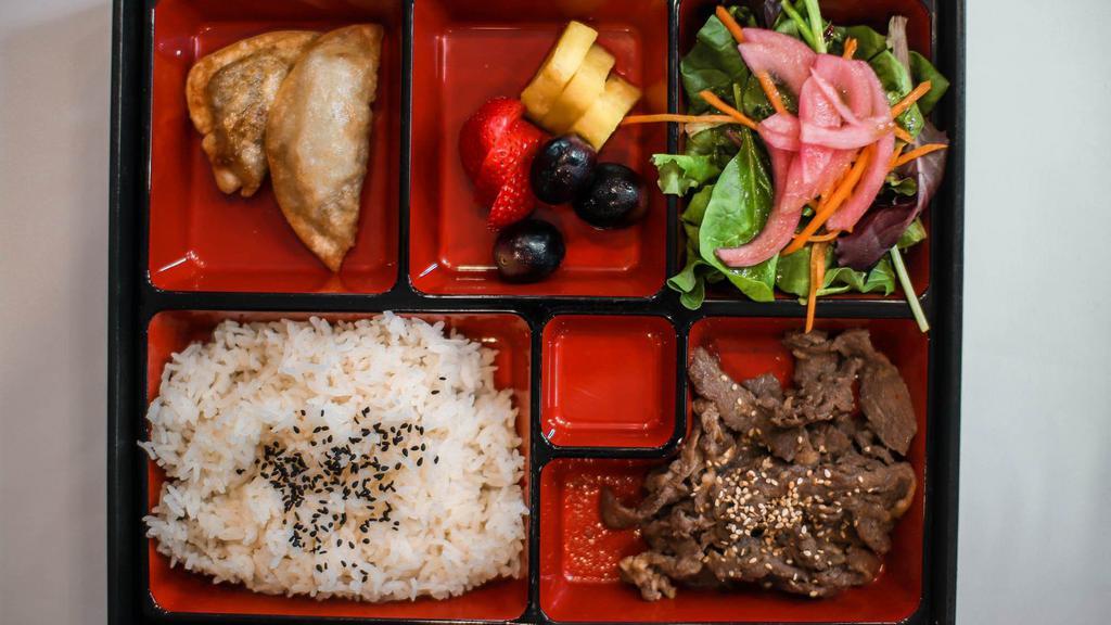 Korean Lunch Box · Rice, protein, salad, two dumplings, and miso soup.