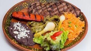 Plato Exclusivo De Carnitas / Carnitas Signature Dish · Carne de cerdo tierna y jugosa servida con arroz, frijoles y salsa verde. / Tender and juicy...