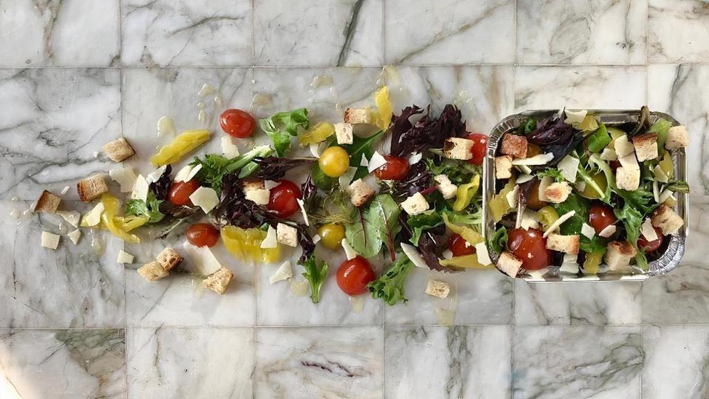 House Salad · Mixed greens, cherry tomatoes, pepperoncinis, shaved parmesan, croutons, and your choice of dressing.
