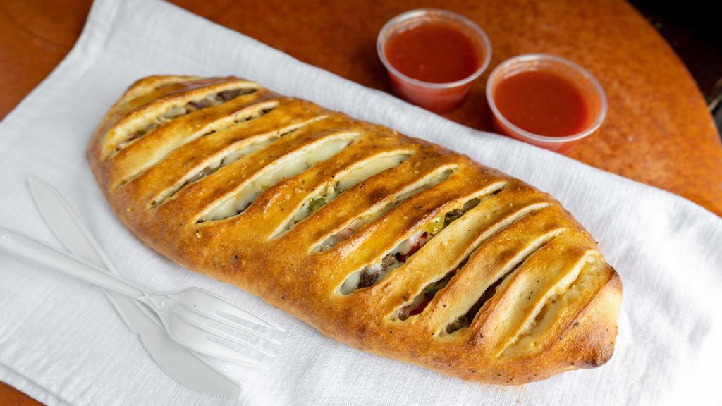 Spicy Steak Philly Stromboli · Spicy steak with Cajun Sauce, Mushrooms, Green Peppers, Onions, Jalapeño Peppers, and Mozzarella Cheese.