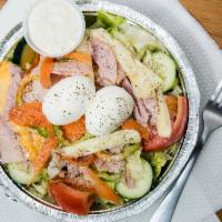 Julienne Salad · Fresh garden crisp greens topped with ham, turkey, American and swiss cheese, hard boiled eg...
