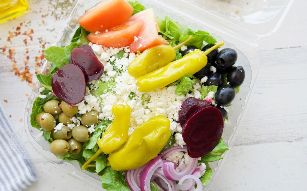 Greek Salad · Romaine lettuce, black and green olives, red onions, tomatoes, beets, pepperoncini, and feta cheese.
