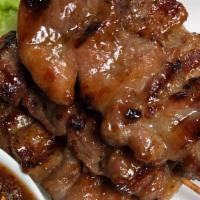 Moo Ping · Marinated grilled pork served with homemade sweet & sour sauce.