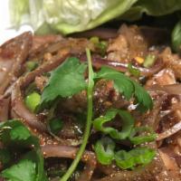 Nam Tok · Grilled beef mixed with red onion, green onion, roasted rice powder, thai chili and spicy li...