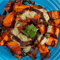 I Am Comforted (Roasted Sweet Potatoes) · Roasted sweet potatoes topped with coconut mint chutney & tamarind sauce, garnished w/ cilan...