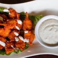 Buffalo Shrimp · 12 panko breaded shrimp tossed in our honey buffalo sauce with ranch drizzle.