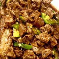 White Goat Meat Tibs · chopped up goat meat with sautéed onion and our special seasoning