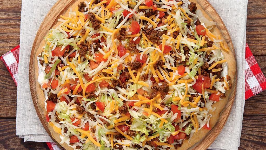 Taco Pizza · Pepperoni, sausage, onions, mushrooms, green peppers, lettuce, tomatoes and topped with cheese.