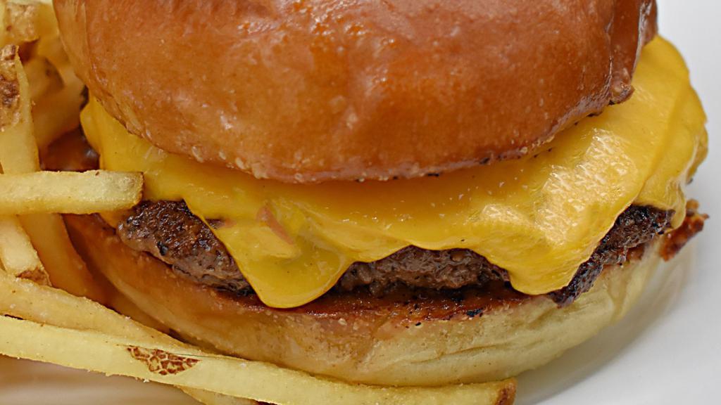 The American Burger · All beef burger patty, American cheese. Add sides or toppings for an additional charge.