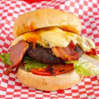 Cajun Country · Spicy blackened burger, bacon, pepper jack cheese, grilled onion, lettuce, tomato and pickles.