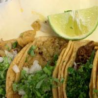 3 Tacos · Corn or flour tortilla, lettuce, tomato and cheese or cilantro and onion.**** all extra topp...