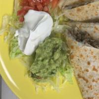 Quesadilla · Choice of meat served with lettuce, tomatoe, guacamole and sour cream.