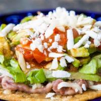 Tostada · Choise a meat. beans, letuce, tomatoe, cheese and sour cream