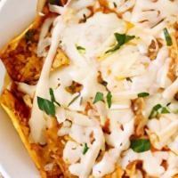Chilaquiles · Chips, red or green salsa, chicken or ground beef, melted cheese. Rice, beans and salad. *th...