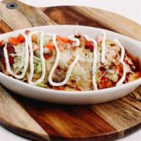 Bodacious Burrito · Served dry or wet: Wet is topped with roja or green chili sauce. Includes baja rice and corn...