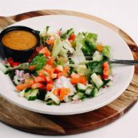 Dinky Salad · Mixed greens with red onions, tomatoes  and cucumber with your choice of dressing. *Gluten f...