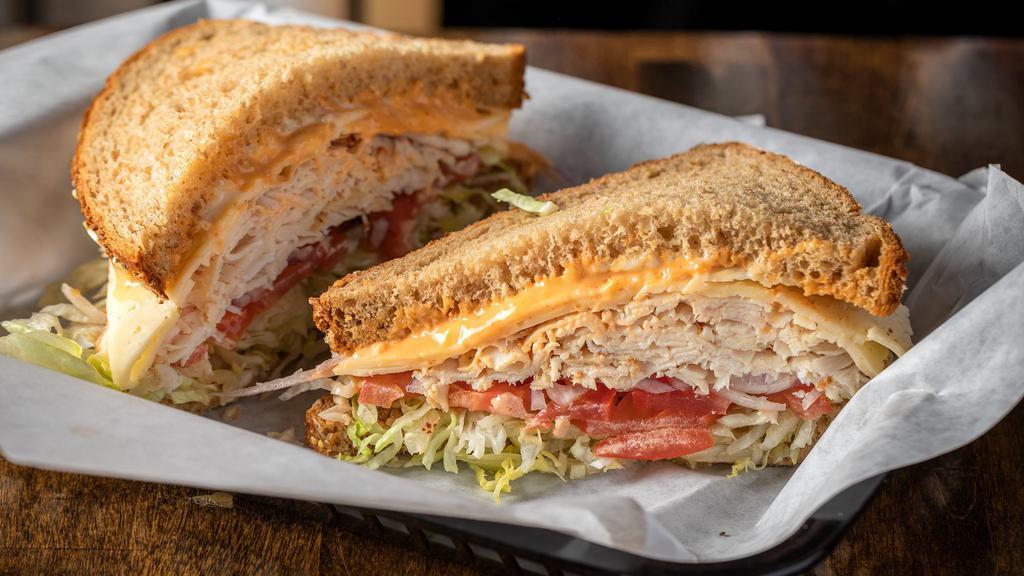 Chipotle Chicken Sandwich · Chipotle chicken with Havarti cheese on multigrain bread. Topped off with lettuce, tomato, red onions, mayonnaise and chipotle dressing.