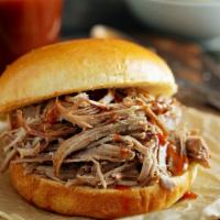 Pulled Pork Sandwich · Slow-smoked pulled pork on a brioche bun, served with house-made chips.