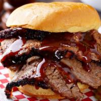Brisket Sandwich · Sliced smoked brisket tossed in our house BBQ sauces, served on a brioche bun with house-mad...