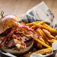 Carnivore Burger · Stacked burger with smoked brisket, pulled pork, cheddar cheese and crispy bacon. Served wit...