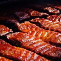 Competition Style Ribs Half Slab · Slow-smoked over a hickory fire. Served with your favorite BBQ sauce
