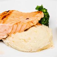 Grilled Salmon Dinner · Grilled Atlantic Salmon brushed with a lemon and dill butter sauce. Served with garlic mashe...