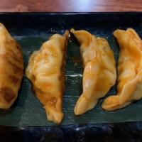 Sweet & Spicy Gyoza · Pan fried dumplings sautéed with sweet and spicy sauce.