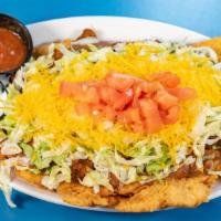 Indian Taco · Homemade Fry Bread Topped with Our Delicious Chili and Bean, Onions, Lettuce, Grated Cheese,...
