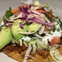 Tostada Chorizo · Mexican sausage , served with Mexican rice, beans and salad