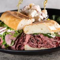 Truffle Pastrami Sandwich · Pastrami on a pressed French roll with lettuce, pickled red onions, and a creamy truffle aio...