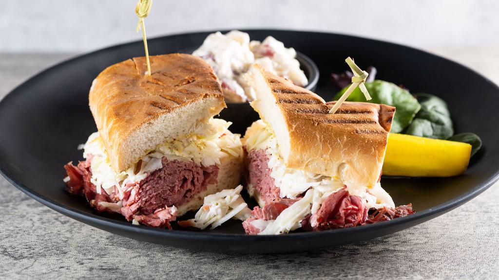 Hot Corned Beef Sandwich · Specialty corned beef on a pressed rye bread, sauerkraut, and thousand island dressing.