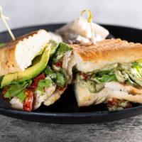 Chicken Pesto Panini · Herb chicken on a pressed French roll with lettuce, avocado, sun dried tomatoes, and a basil...