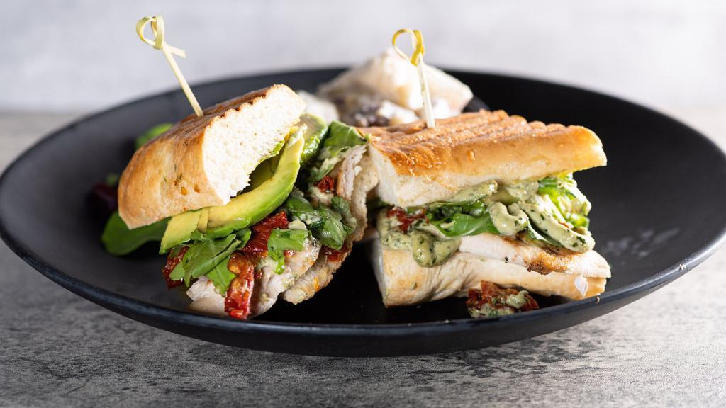 Chicken Pesto Panini · Herb chicken on a pressed French roll with lettuce, avocado, sun dried tomatoes, and a basil pesto.