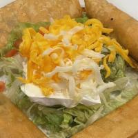 Taquitos Mexicanos · Four taquitos filled with chicken or picadillo, served with lettuce, cheese, guacamole, sour...
