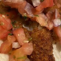 Fish Tacos · Three tacos stuffed with battered and fried fish. served with lettuce, pico de gallo, rice a...