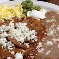 Chilaquiles · Tortilla chips simmered in green or red sauce. Served with rice and beans.