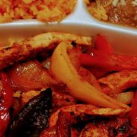 Chicken Fajitas · Grilled chicken with red peppers, green peppers, yellow peppers and onions. Served with rice...