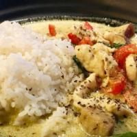Green Curry · Spicy. Chicken, eggplant, bamboo shoots, peppers, cooked in a savory coconut milk and green ...
